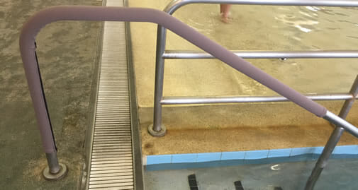 pool handrail cover on railing in gym pool